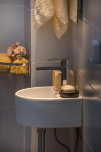 a white sink in a bathroom with some towels at 4k GEM in Ierápetra +39 photos