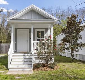 a small white house with a white door and stairs at Best Cottage in Ocean Springs- GOLF CART INCLUDED!!! in Ocean Springs