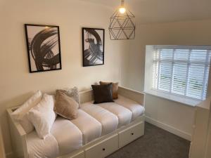 a living room with a couch and a window at Lux Cottage Conwy in Conwy