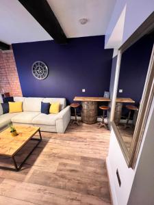 a living room with a couch and a table at Stunning Liverpool City Center Apartment in Liverpool