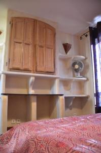 a bedroom with wooden cabinets and a red bed at Portman cosy in Toulon