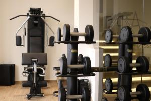 a room with a bunch of weights and a gym at Tenuta Contessa - Relais & Spa in Montalto Uffugo