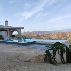 a house with a swimming pool with mountains in the background at Villa Kefali in Kavoúsion
