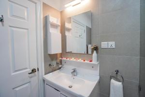 a bathroom with a sink and a mirror at Willows Cottage - Little England Cottages in Nuwara Eliya +23 photos