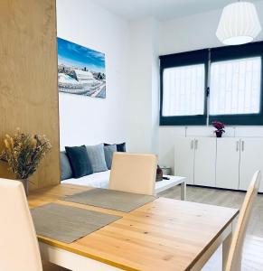 a living room with a wooden table and a dining room at Vivienda Turística las Ciencias in Valencia