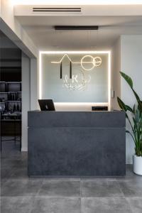 a reception desk with a laptop on top of it at Reflection Boutique Hotels in Toscolano Maderno