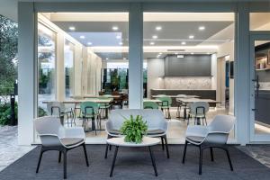 a dining room with tables and chairs and a screen at Reflection Boutique Hotels in Toscolano Maderno