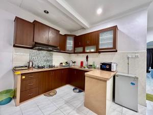 a kitchen with wooden cabinets and a counter top at Home14#2pax#Wifi&Netflix#NearAeonAlma&Lotus in Bukit Mertajam