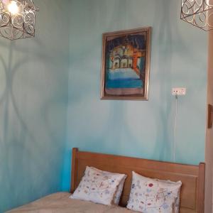 a bedroom with a bed and a painting on the wall at Casa das Amoras in Santo António das Areias +31 photos