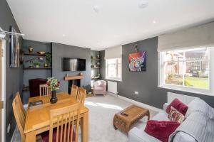 a living room with a table and a couch at The Lettered Board Apartments in Pickering