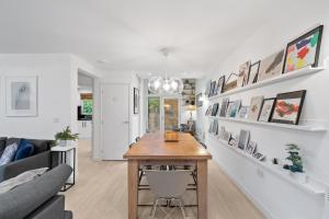 a living room with a table and a couch at Tincroft Cottage - high end, luxury living near the beach in Truro