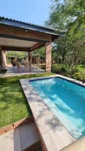 a swimming pool in a yard with a pavilion at Sonop in Marloth Park in Marloth Park
