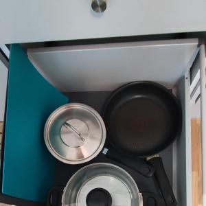 two pots and pans in a blue box at Ruby studio 5min to Vantaa Airport and 20min to Helsinki center in Vantaa
