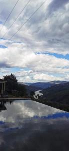 a pool of water with a view of a river at Casa De Canilhas in Mesão Frio +67 photos
