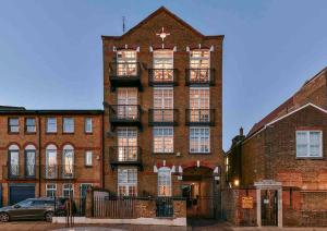 a large brick building with a balcony on it at Dovecote - sanctuary in the sky in London