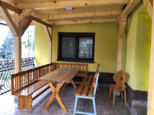 drewniany stół i krzesła na ganku domu w obiekcie Chata Oravská Priehrada w Namiestowie
