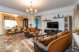 a living room with couches and a dining room at Sweet Dreams in Chorafakia