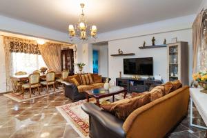 a living room with couches and a dining room at El-Ni-Noe in Chorafakia