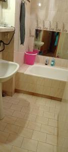 a bathroom with a tub and a sink at Warszawska 