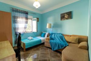 a blue living room with a couch and a table at Sweet Dreams in Chorafakia