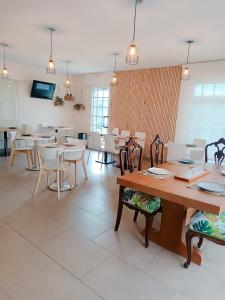 a dining room with tables and chairs in a room at Apartamentos Rodeiramar 2A in Cangas de Morrazo