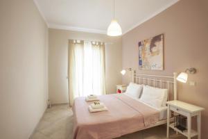 A bed or beds in a room at Kassiopi Seafront Elegant Apartments