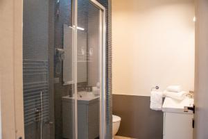 a bathroom with a shower with a toilet and a sink at Sirena Partenope e San Gennaro HOME - Rione Sanità - Centro Storico Napoli in Naples