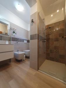 a bathroom with a shower and a toilet and a sink at Casa Valenti in Brenzone sul Garda