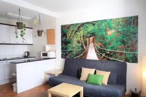 a living room with a couch and a painting on the wall at Hub Hostel Seville in Seville