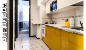a kitchen with yellow cabinets and a yellow counter top at Duomo Luxury House 9 Pax in Milan