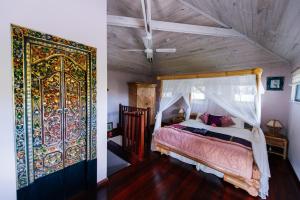 a bedroom with a bed and a large door at Riveresque in Margaret River Town
