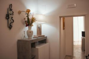 a room with a table with a vase on it at Casa Morrone Residence in Corato +30 photos