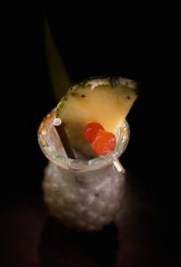 a close up of a piece of fruit with a drink at The Lovina Place in Watumulla