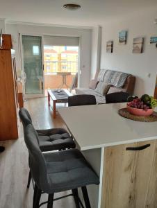 a kitchen and living room with a table and chairs at apartamento Gandiazar 4 playa, VT-52979-V in Playa de Gandia