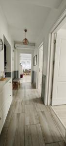 a large room with a hallway with wooden floors at Apartament 1 Mai bloc nou-Self check-in in Craiova