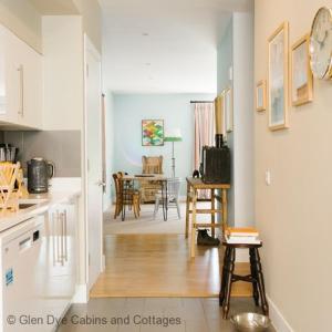 a kitchen and living room with a table and chairs at Number 2 Steading Cottage in Banchory