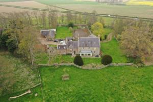 an aerial view of a large house in a field at Buckton Farmhouse in Belford