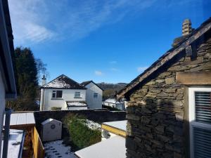 a view from the balcony of a stone house at Ellerhow in Windermere