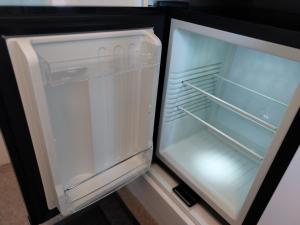 an empty refrigerator with its door open in a kitchen at Ellerhow in Windermere