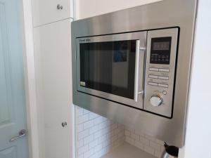 a stainless steel microwave oven in a kitchen at Ellerhow in Windermere