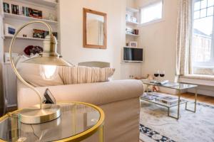 a living room with a couch and a glass table at No 12 Southwold in Southwold