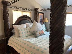 a bedroom with a canopy bed with pillows on it at Beautiful and Relaxing Guest House!! in Redding