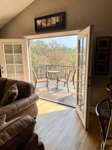 a living room with a door open to a deck at Beautiful and Relaxing Guest House!! in Redding