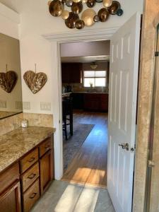 a kitchen with a door open to a kitchen with hearts on the wall at Beautiful and Relaxing Guest House!! in Redding