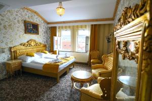 a bedroom with a bed and a table and chairs at Hotel Liliova Prague Old Town in Prague