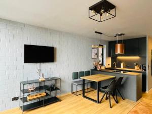 a living room with a table and a kitchen at Harzchalet Emma 2 in Sankt Andreasberg