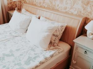 a bed with two pillows on top of it at Family Hotel in Daugavpils