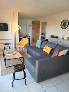 sala de estar con sofá azul y mesa en maison de vacances locquirec en Locquirec