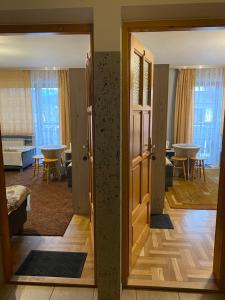 a room with a door open to a living room at Domek Okno na Tatry - Dom na wyłączność in Poronin