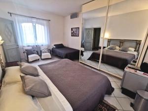 a large bedroom with two beds and a mirror at B&B Parco degli Ulivi in Misano Adriatico